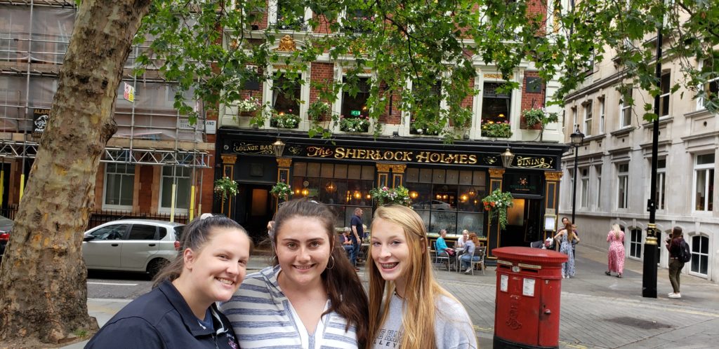 Girls in front  of Sherlock Holmes Pub, London, England, Summer Three-city tour