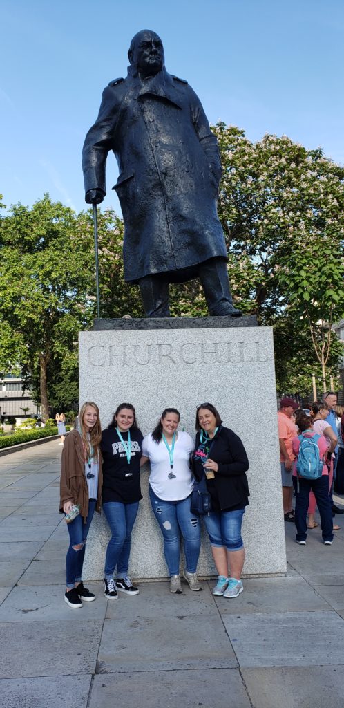 Girls in front of Churchill statue, London, England, Summer Three-city tour